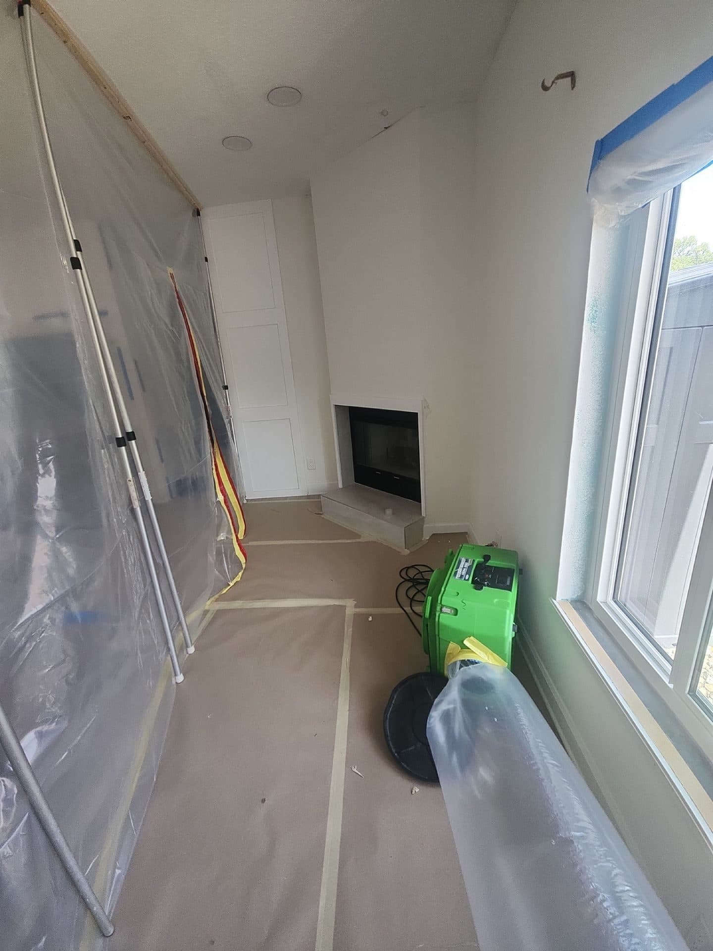 Containment sheeting and drying equipment set up in a living room