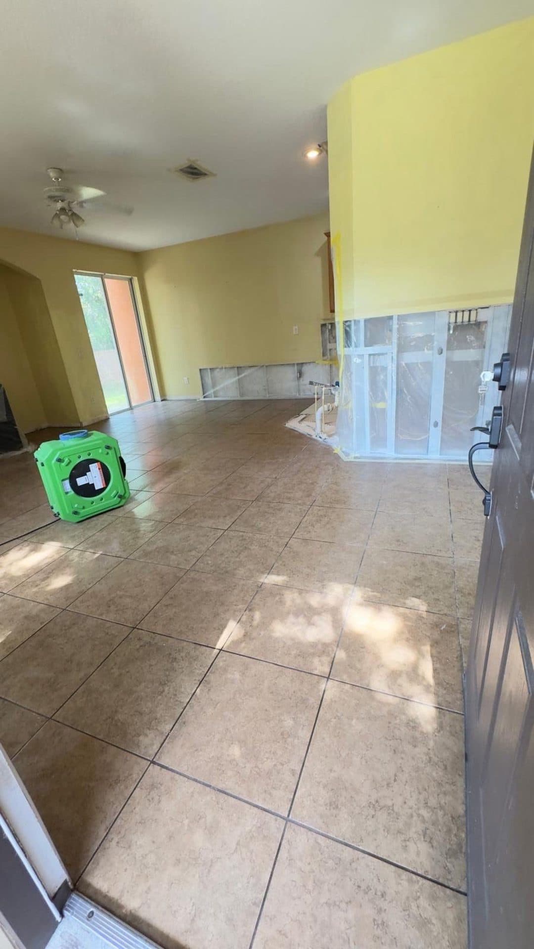 An air mover running to dry a room after water damage